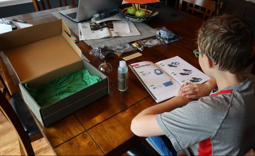 Begining the STEM project by building the base. He will begin to put them together piece by piece by following the instruction manual. It's a great Christmas gift, and the lock box project (another Kiwico box project)